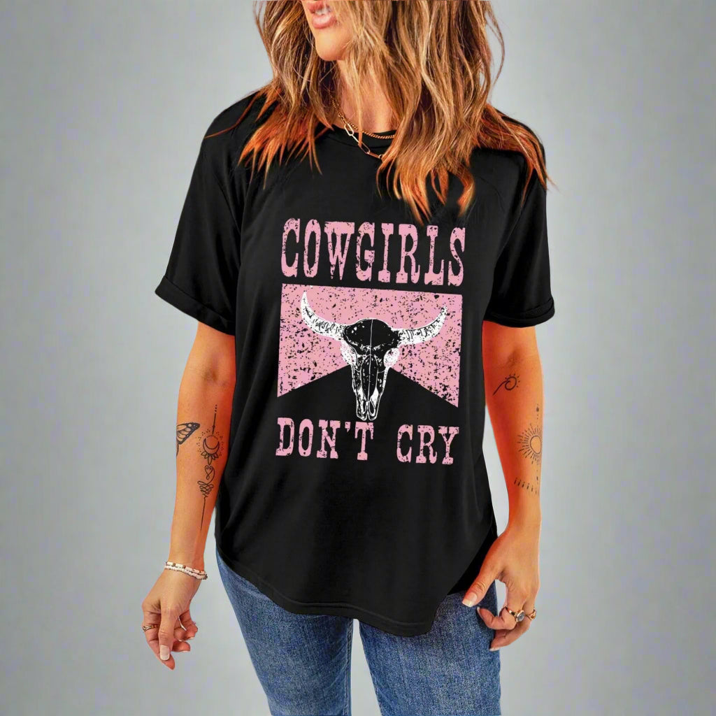 Person wearing a black t-shirt with 'Cowgirls Don't Cry' graphic design.
