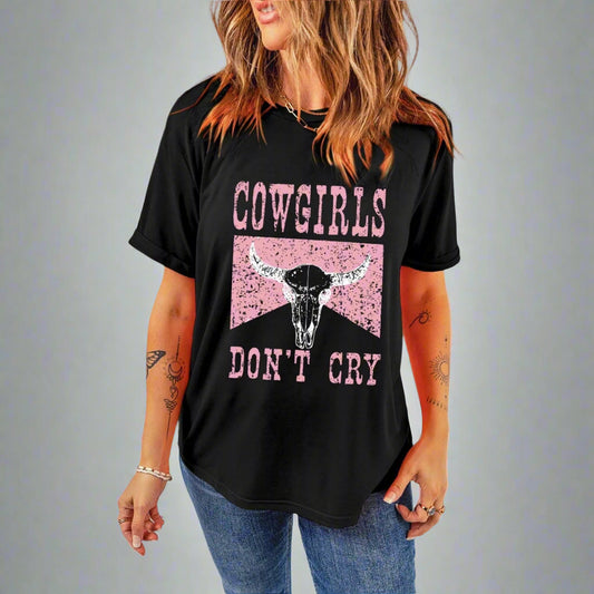 Person wearing a black t-shirt with 'Cowgirls Don't Cry' graphic design.