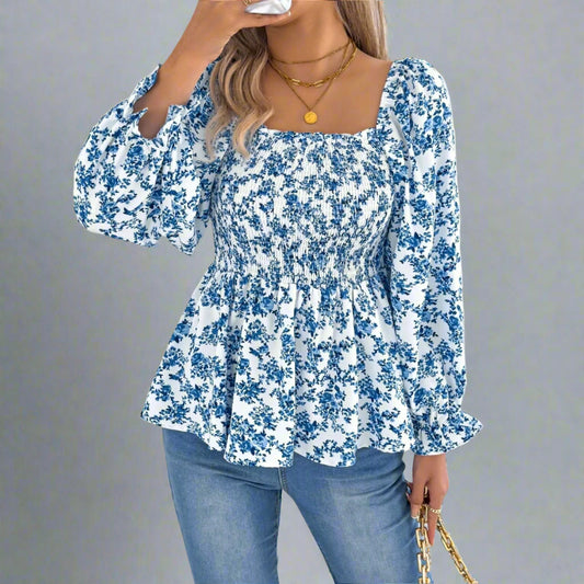 Woman wearing a blue floral blouse and jeans on a white background