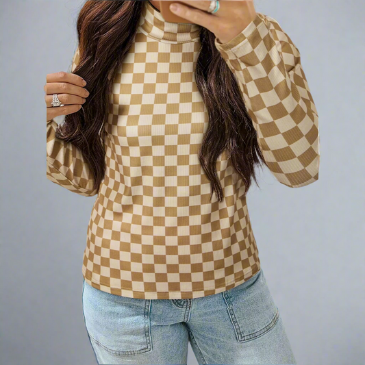 Person wearing a brown and beige checkered long-sleeve top with light blue jeans on a gray background